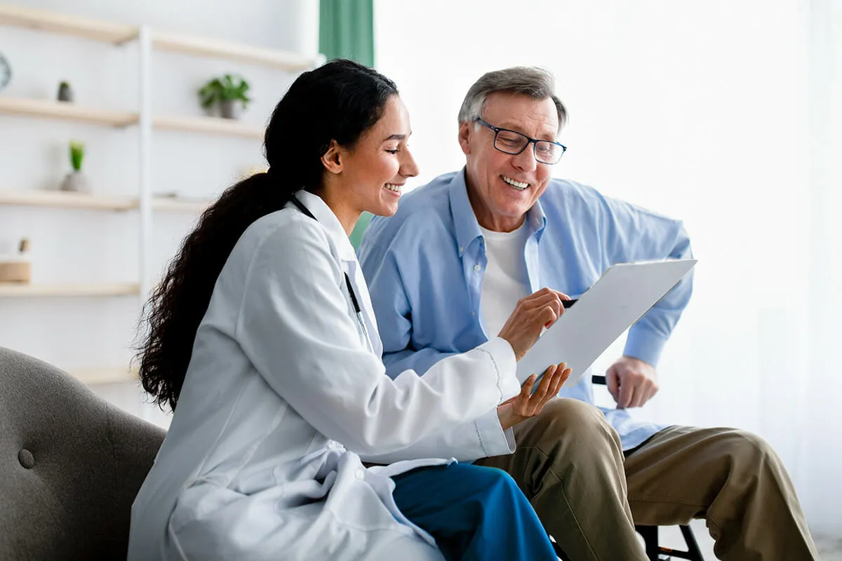 Doctor showing intake form to elderly patient